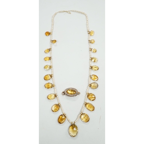 1933 - An Edwardian twenty one graduated oval cut citrine set  seed pearl necklace (a.f) clasp loose, appro... 