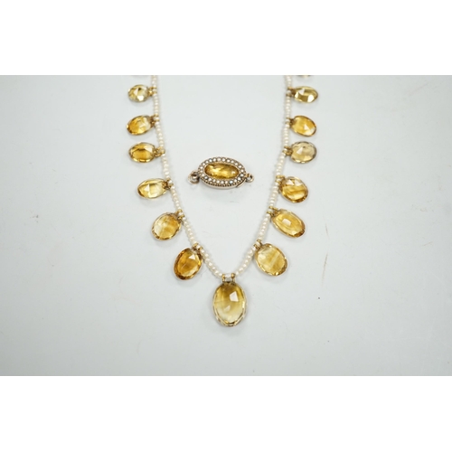 1933 - An Edwardian twenty one graduated oval cut citrine set  seed pearl necklace (a.f) clasp loose, appro... 