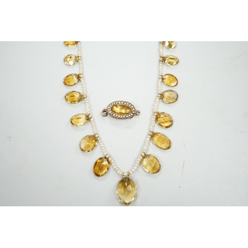 1933 - An Edwardian twenty one graduated oval cut citrine set  seed pearl necklace (a.f) clasp loose, appro... 