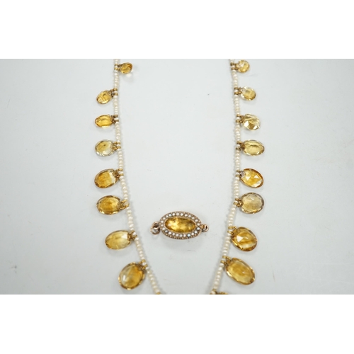 1933 - An Edwardian twenty one graduated oval cut citrine set  seed pearl necklace (a.f) clasp loose, appro... 