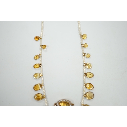 1933 - An Edwardian twenty one graduated oval cut citrine set  seed pearl necklace (a.f) clasp loose, appro... 