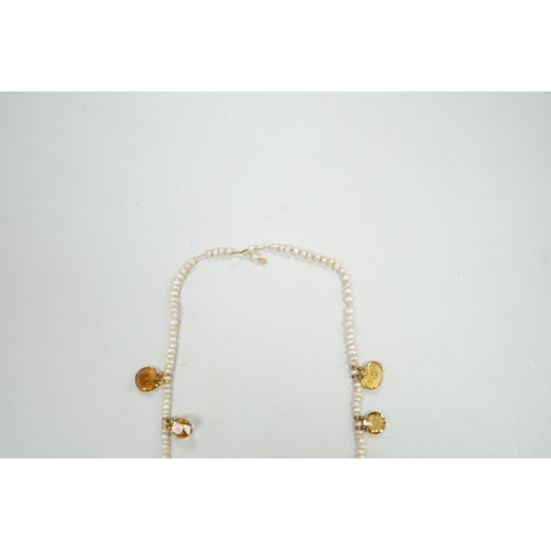 1933 - An Edwardian twenty one graduated oval cut citrine set  seed pearl necklace (a.f) clasp loose, appro... 