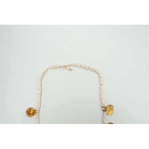 1933 - An Edwardian twenty one graduated oval cut citrine set  seed pearl necklace (a.f) clasp loose, appro... 