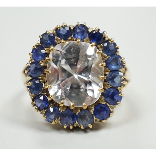 1934 - An early 20th century yellow metal and single stone cushion cut white sapphire set dress ring, borde... 