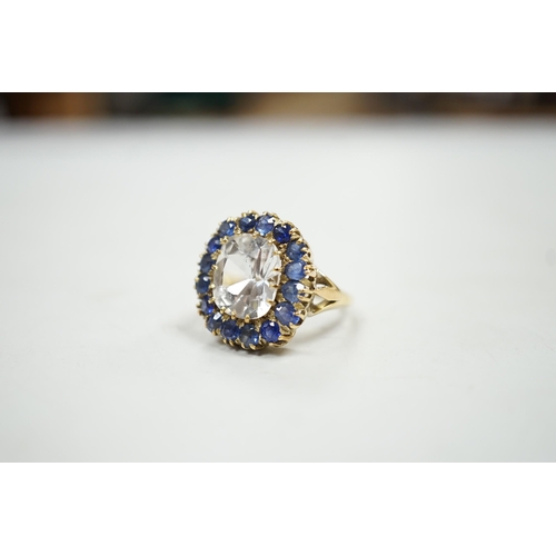 1934 - An early 20th century yellow metal and single stone cushion cut white sapphire set dress ring, borde... 