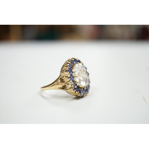 1934 - An early 20th century yellow metal and single stone cushion cut white sapphire set dress ring, borde... 