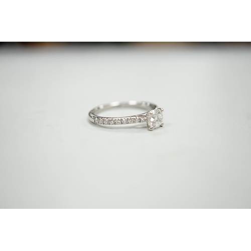 1936 - A modern platinum and single stone diamond ring, with diamond set shoulders and accompanying Gabriel... 