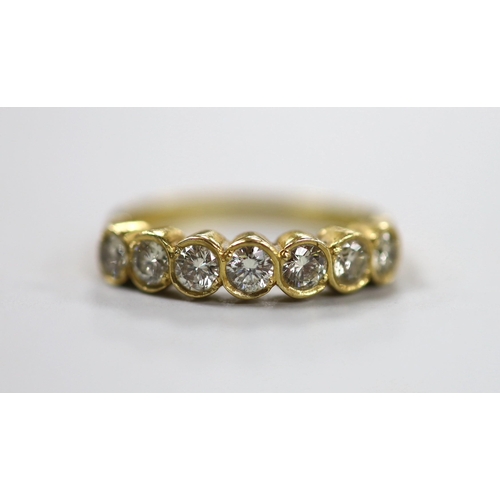 1943 - A modern 750 yellow metal and seven stone diamond set half hoop ring, size O, gross weight 3.2 grams... 