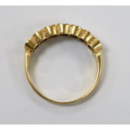 1943 - A modern 750 yellow metal and seven stone diamond set half hoop ring, size O, gross weight 3.2 grams... 