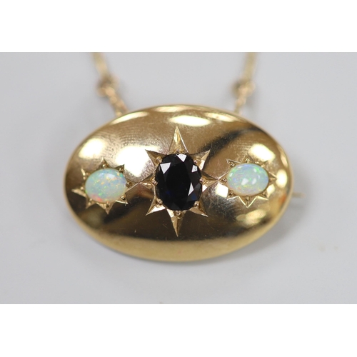 1944 - A 1970's 9ct gold and gypsy set single stone sapphire and two stone white opal set oval pendant broo... 