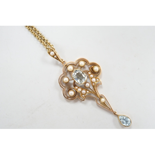 1948 - An Edwardian 15ct, aquamarine and seed pearl set drop pendant, 56mm, gross weight 5.3 grams, on a gi... 