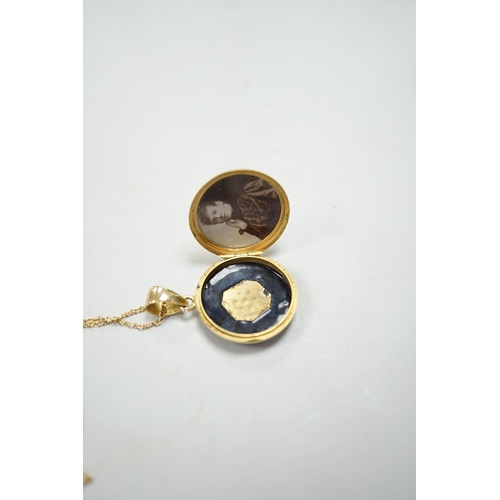 1949 - A late Victorian 15ct, black enamel and seed pearl set circular mourning locket, diameter 23mm, on a... 