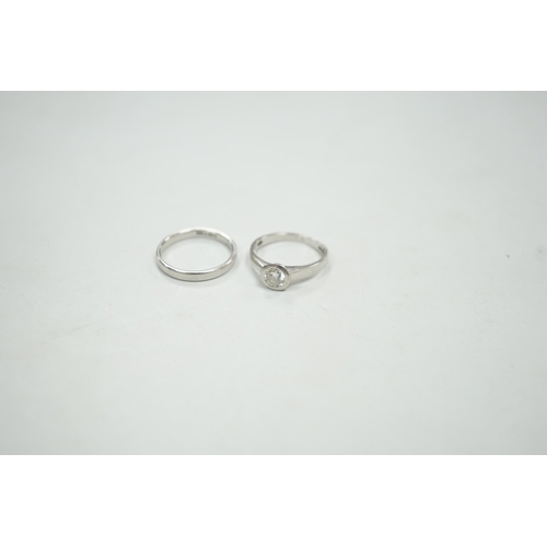 1953 - A modern platinum and collet set solitaire diamond ring, size M, gross weight 4.9 grams, together wi... 