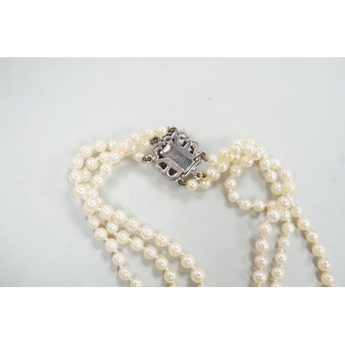 1962 - A 1960's triple strand graduated cultured pearl necklace, with 9ct white gold, ruby and diamond chip... 