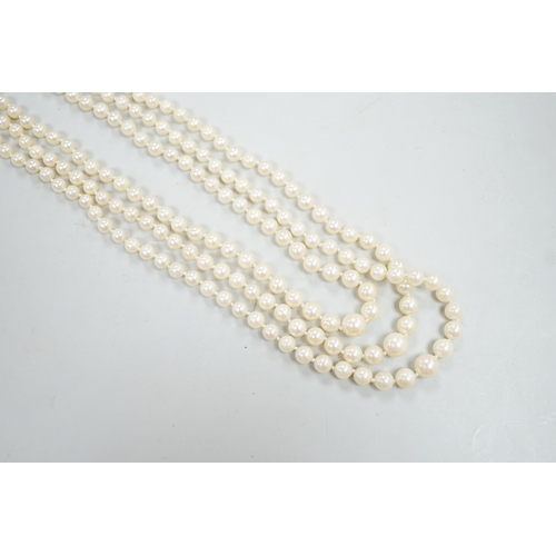 1962 - A 1960's triple strand graduated cultured pearl necklace, with 9ct white gold, ruby and diamond chip... 