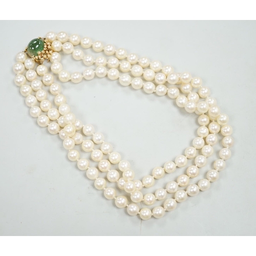 1964 - A mid to late 29th century triple strand cultured pearl choker necklace, with 14k and cabochon emera... 