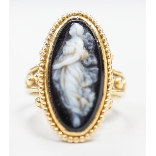 1965 - An early 20th century yellow metal and black sardonyx set cameo ring, carved with the figure of a cl... 