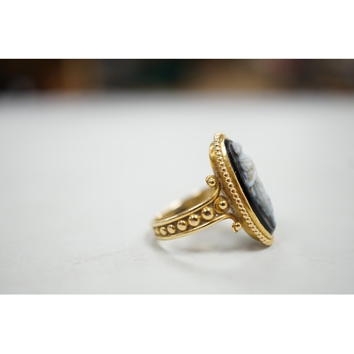 1965 - An early 20th century yellow metal and black sardonyx set cameo ring, carved with the figure of a cl... 