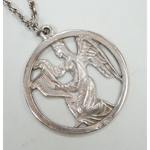 1968 - A late 1970's John Skelton silver pendant, depicting an angel with harp, diameter 63mm, on a sterlin... 