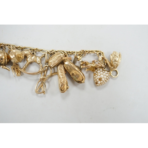 1972 - A 9ct charm bracelet, hung with assorted mainly 9ct gold charms, gross weight 46.1 grams.