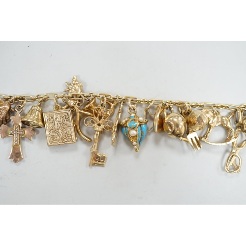 1972 - A 9ct charm bracelet, hung with assorted mainly 9ct gold charms, gross weight 46.1 grams.