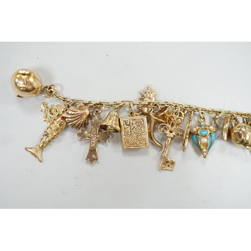 1972 - A 9ct charm bracelet, hung with assorted mainly 9ct gold charms, gross weight 46.1 grams.