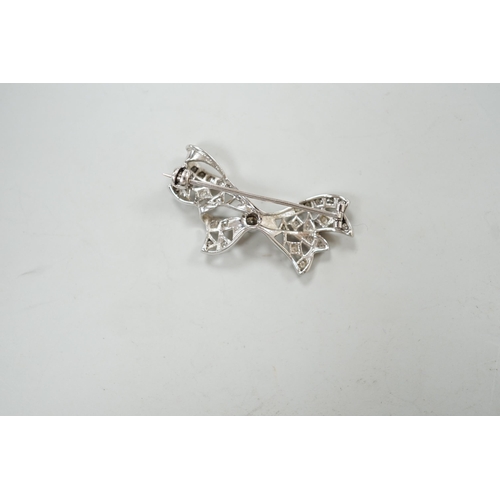 1973 - A white metal and diamond cluster set ribbon bow brooch, 36mm, gross weight 4 grams.