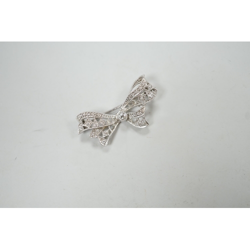 1973 - A white metal and diamond cluster set ribbon bow brooch, 36mm, gross weight 4 grams.