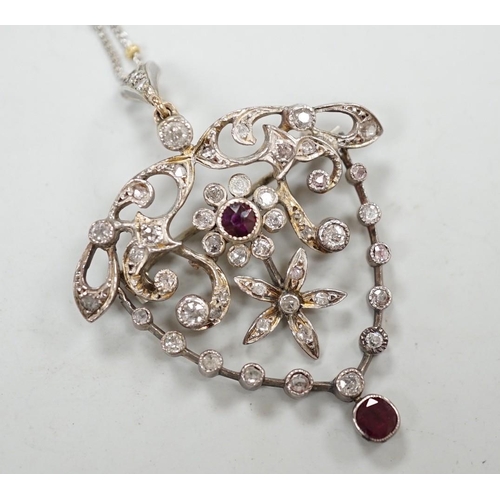 1980 - A yellow and white metal, ruby and diamond cluster set drop pendant brooch, 49mm, on an 18ct gold ch... 