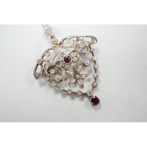 1980 - A yellow and white metal, ruby and diamond cluster set drop pendant brooch, 49mm, on an 18ct gold ch... 