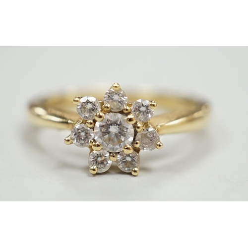 1981 - A modern yellow metal and diamond set flower head cluster ring, size L, gross weight 2.9 grams.... 