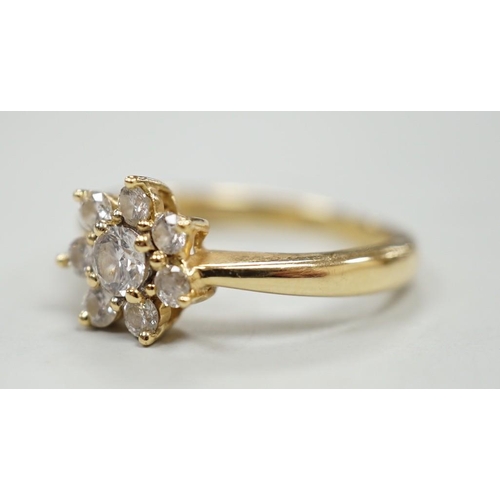 1981 - A modern yellow metal and diamond set flower head cluster ring, size L, gross weight 2.9 grams.... 