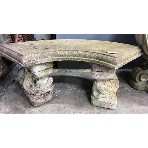 1 - A reconstituted stone curved garden bench with dolphin supports, length 98cm, depth 46cm, height 43c... 