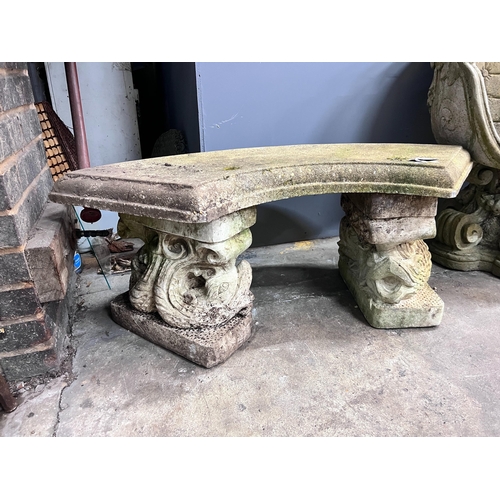 1 - A reconstituted stone curved garden bench with dolphin supports, length 98cm, depth 46cm, height 43c... 