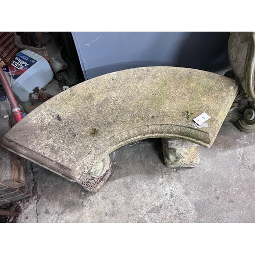 1 - A reconstituted stone curved garden bench with dolphin supports, length 98cm, depth 46cm, height 43c... 