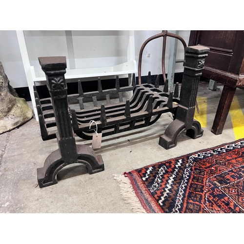 11 - A cast iron fire grate, length 61cm, depth 33cm and a pair of fire dogs *Please note the sale commen... 