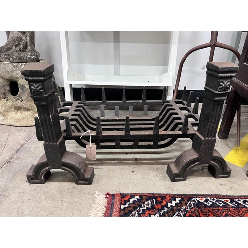 11 - A cast iron fire grate, length 61cm, depth 33cm and a pair of fire dogs *Please note the sale commen... 