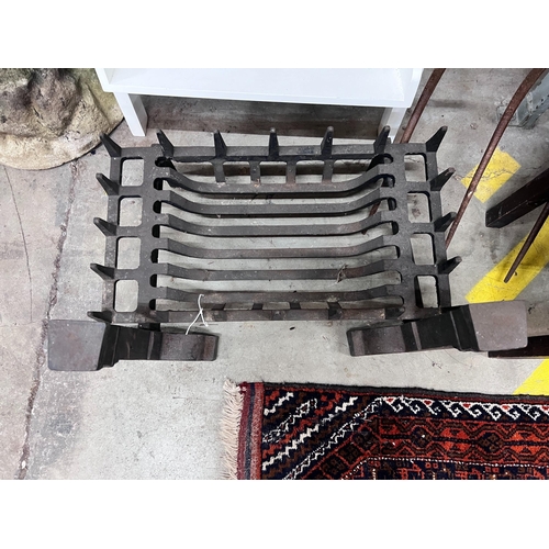 11 - A cast iron fire grate, length 61cm, depth 33cm and a pair of fire dogs *Please note the sale commen... 