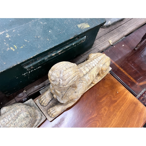 119 - A pair of composition faux marble sphinx, length 48cm, height 30cm *Please note the sale commences a... 