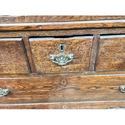 131 - A George III oak press cupboard with two panelled doors over five drawers, width 111cm, depth 53cm, ... 