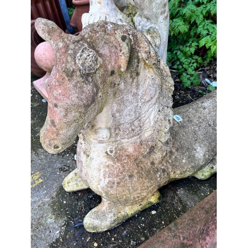 145 - A reconstituted stone recumbent horse, height 55cm *Please note the sale commences at 9am.