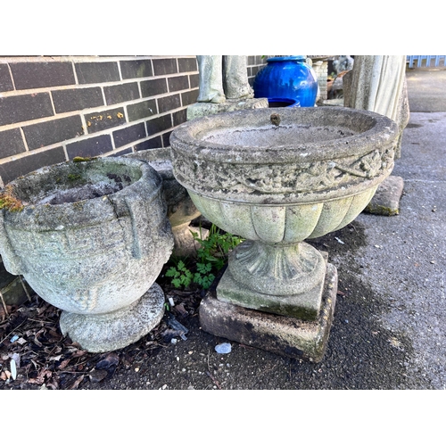 148 - Three circular reconstituted stone garden planters, largest diameter 46cm, height 49cm *Please note ... 