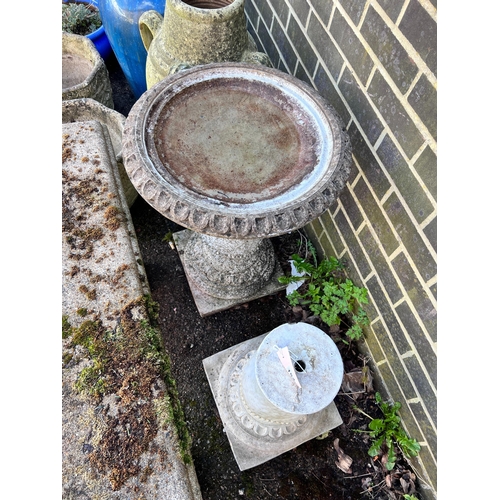 154 - A circular reconstituted stone bird bath, diameter 50cm, height 62cm together with a faux marble ped... 