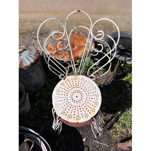 162 - A circular wrought iron garden table and four chairs, diameter 50cm, height 80cm *Please note the sa... 