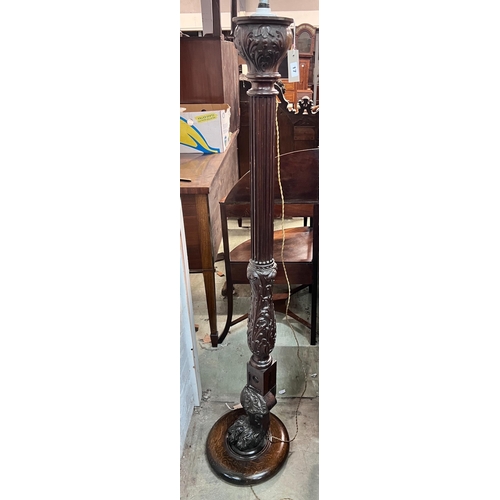 17 - A carved oak and mahogany carved standard lamp, height 151cm *Please note the sale commences at 9am.... 