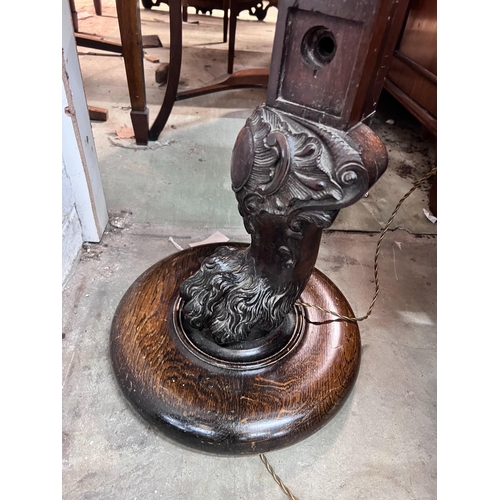 17 - A carved oak and mahogany carved standard lamp, height 151cm *Please note the sale commences at 9am.... 