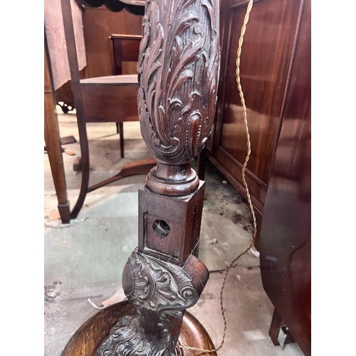 17 - A carved oak and mahogany carved standard lamp, height 151cm *Please note the sale commences at 9am.... 