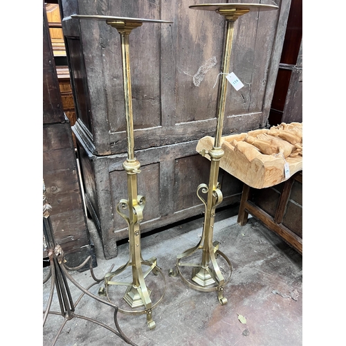 174 - A pair of ecclesiastical brass telescopic candle stands, maximum height 135cm *Please note the sale ... 