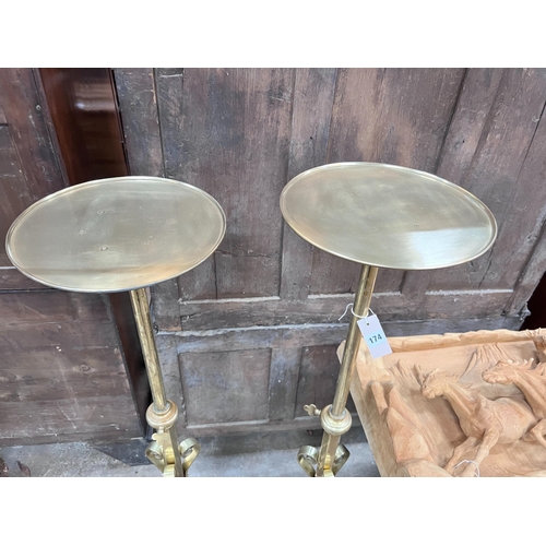 174 - A pair of ecclesiastical brass telescopic candle stands, maximum height 135cm *Please note the sale ... 