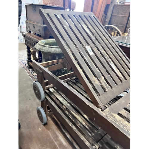 224 - A pair of weathered teak steamer chairs, length 197cm *Please note the sale commences at 9am.